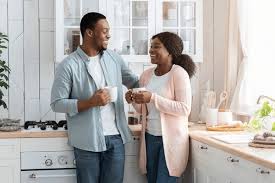 a couple enjoying a cup of coffee in the kitchen